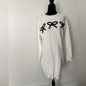 Dreamers by debut knit sweater dress with black bow detail. Size medium.